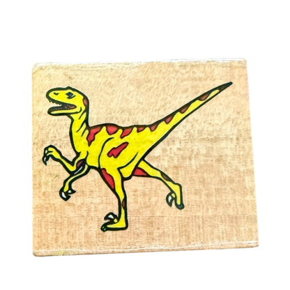 Yellow dinosaur illustration on a beige block