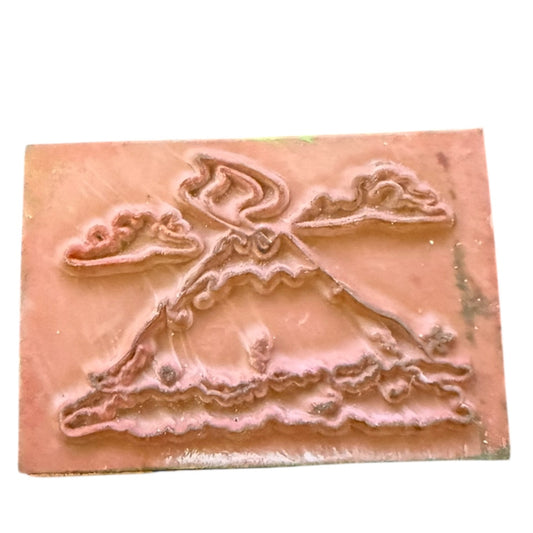 Volcano embossed design stamp on a white background