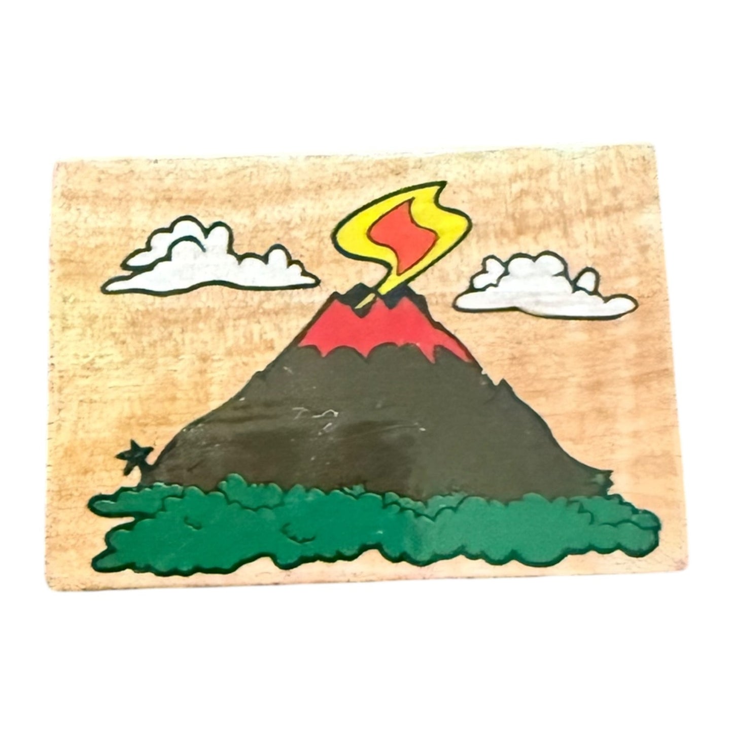 Wooden stamp with a volcano design on a white background