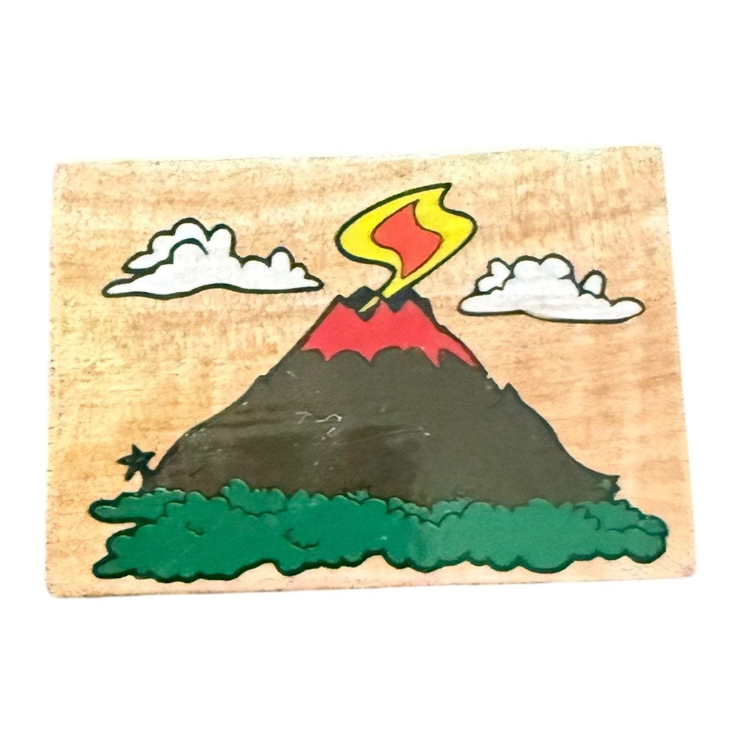 Wooden stamp with a volcano design on a white background