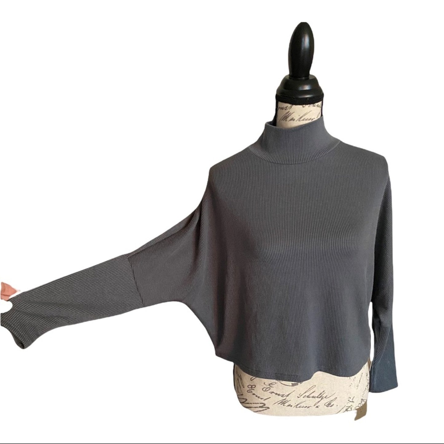 Gray mock turtleneck shirt on a mannequin with a white background