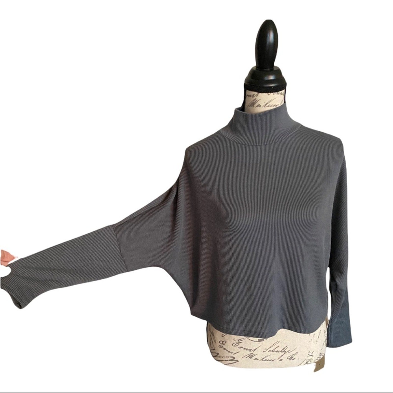 Gray mock turtleneck shirt on a mannequin with a white background