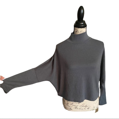 Gray mock turtleneck shirt on a mannequin with a white background