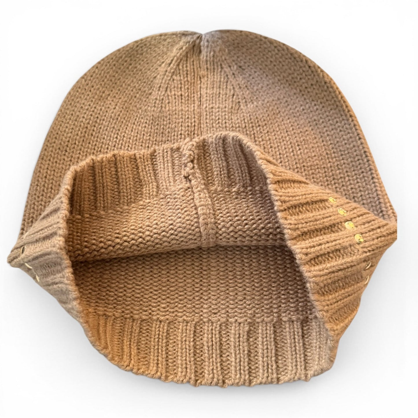 Beige knit beanie on a white background