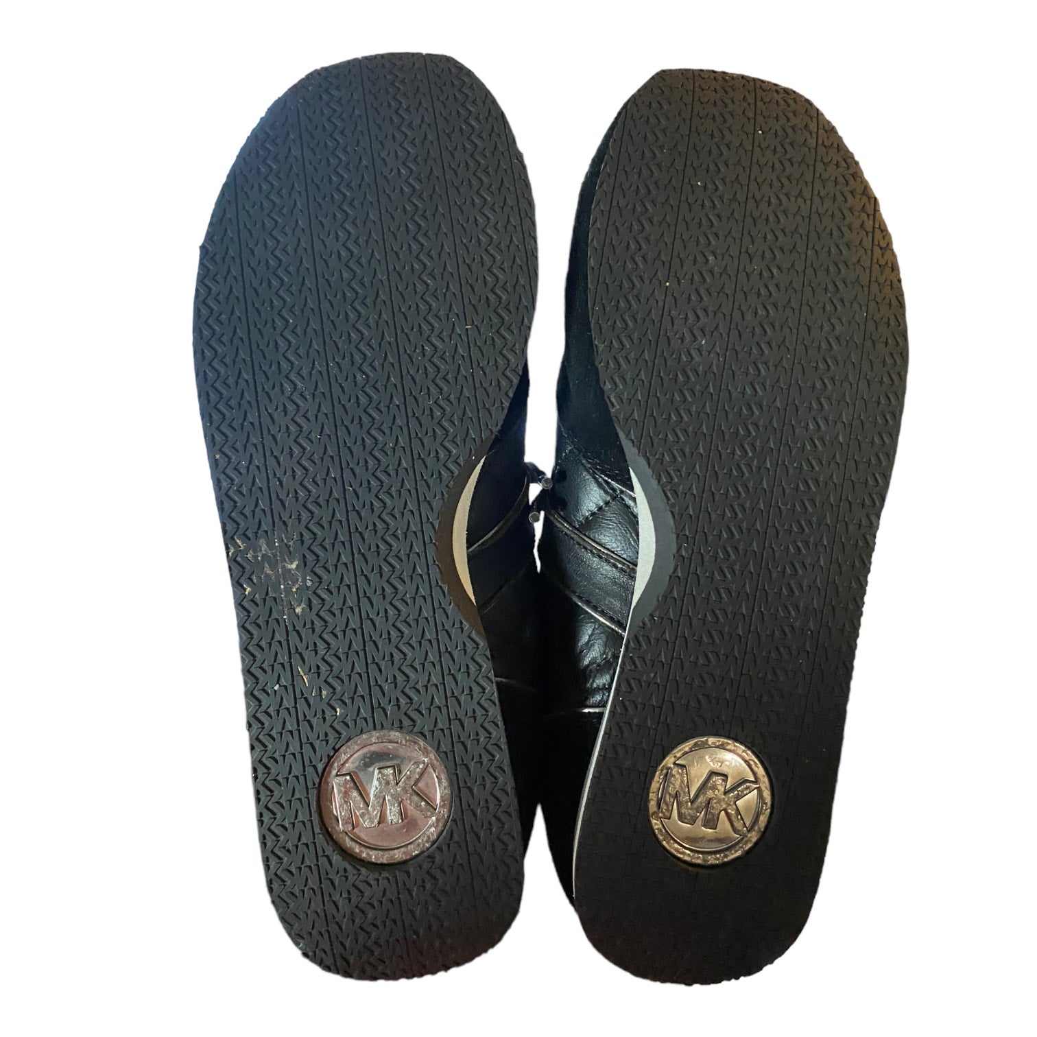 Black leather shoes with brand logo on soles against a white background
