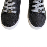 Sparkle front of black Michael Kors sneakers