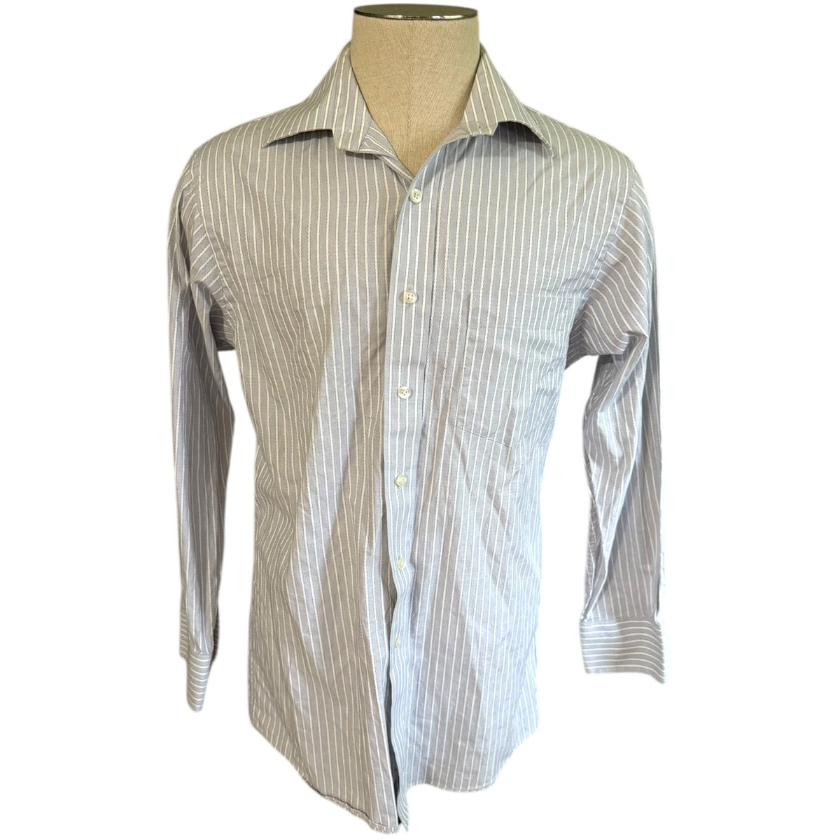 A men's long-sleeve button-down shirt with vertical pinstripes, displayed on a beige dress form mannequin against a plain white background.