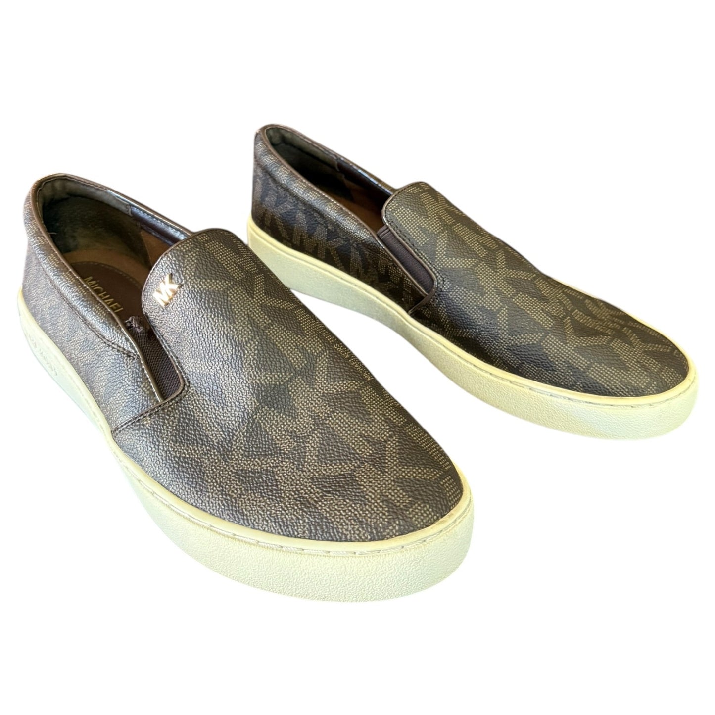 Front side of brown MK patterned slip-on shoes on a white background