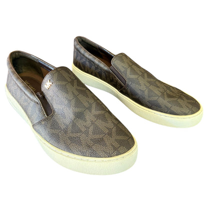 Front side of brown MK patterned slip-on shoes on a white background