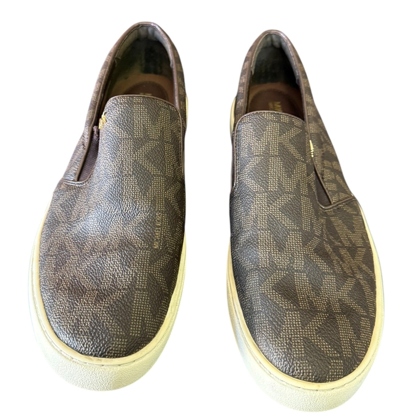 Front of MK patterned slip-on shoes on a white background
