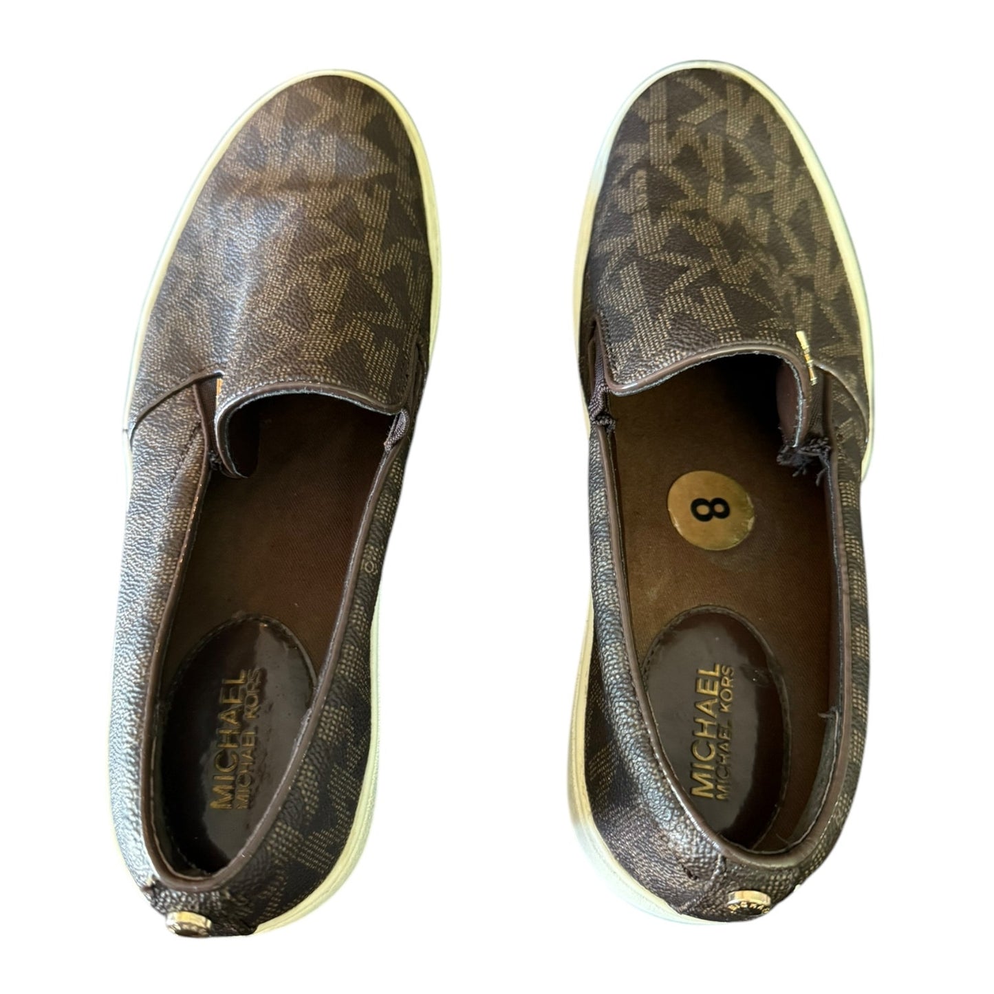 Top of a Pair of brown MK patterned shoes with 'Michael' branding on a white background