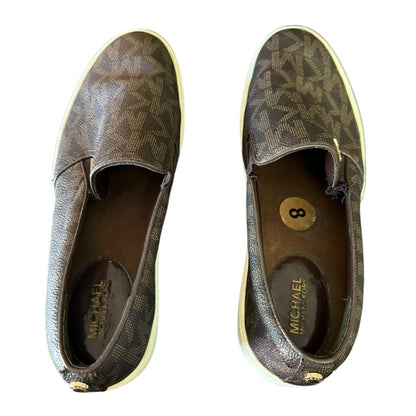 Top of a Pair of brown MK patterned shoes with 'Michael' branding on a white background