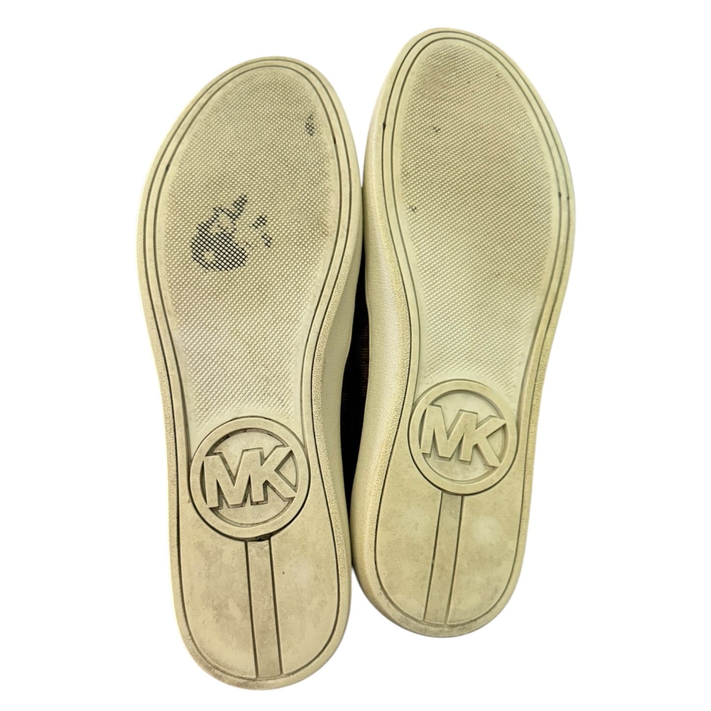 Shoe soles with Michael Kors logo on a white background