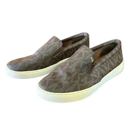 Brown MK patterned slip-on shoes on a white background
