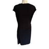 Back of Black dress on a mannequin against a white background