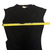 Black sleeveless top with a measuring tape across it on a white background