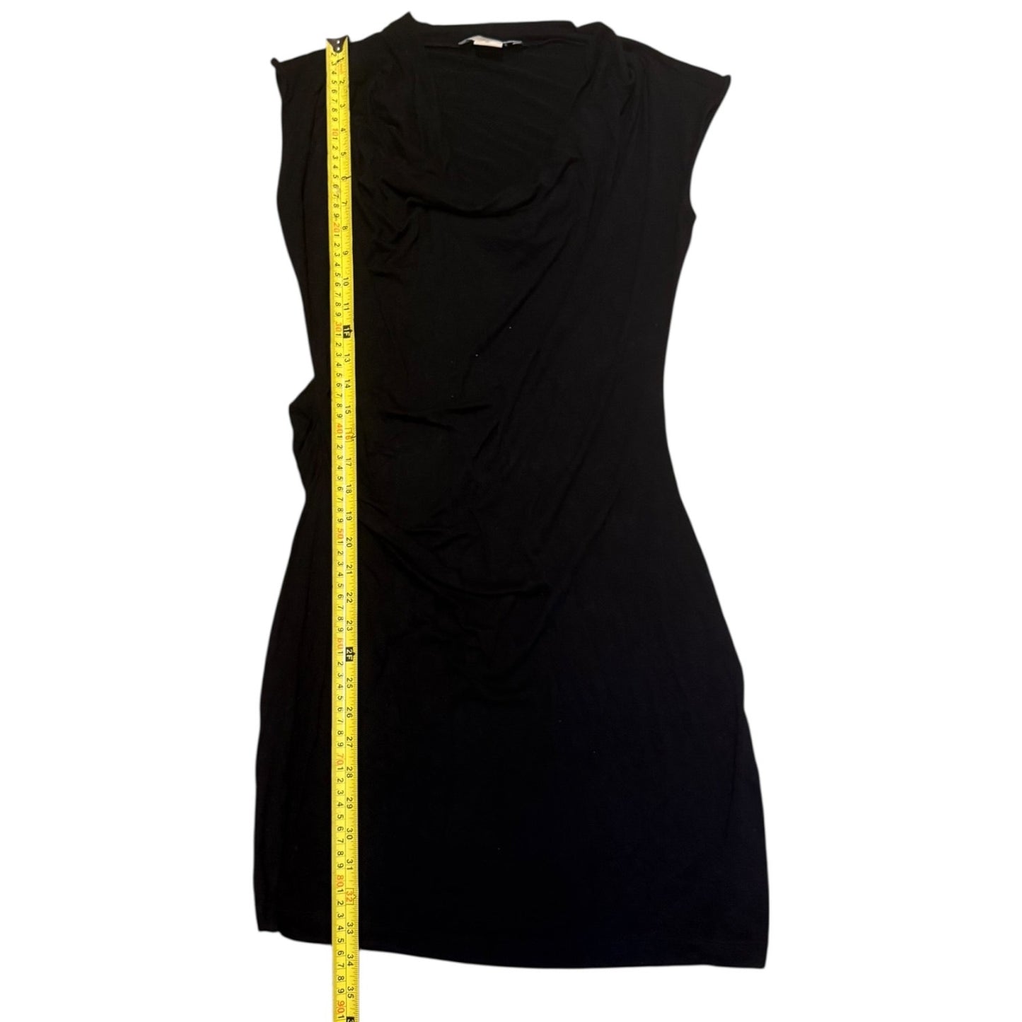 Black sleeveless dress with a measuring tape on a white background