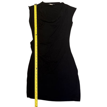 Black sleeveless dress with a measuring tape on a white background