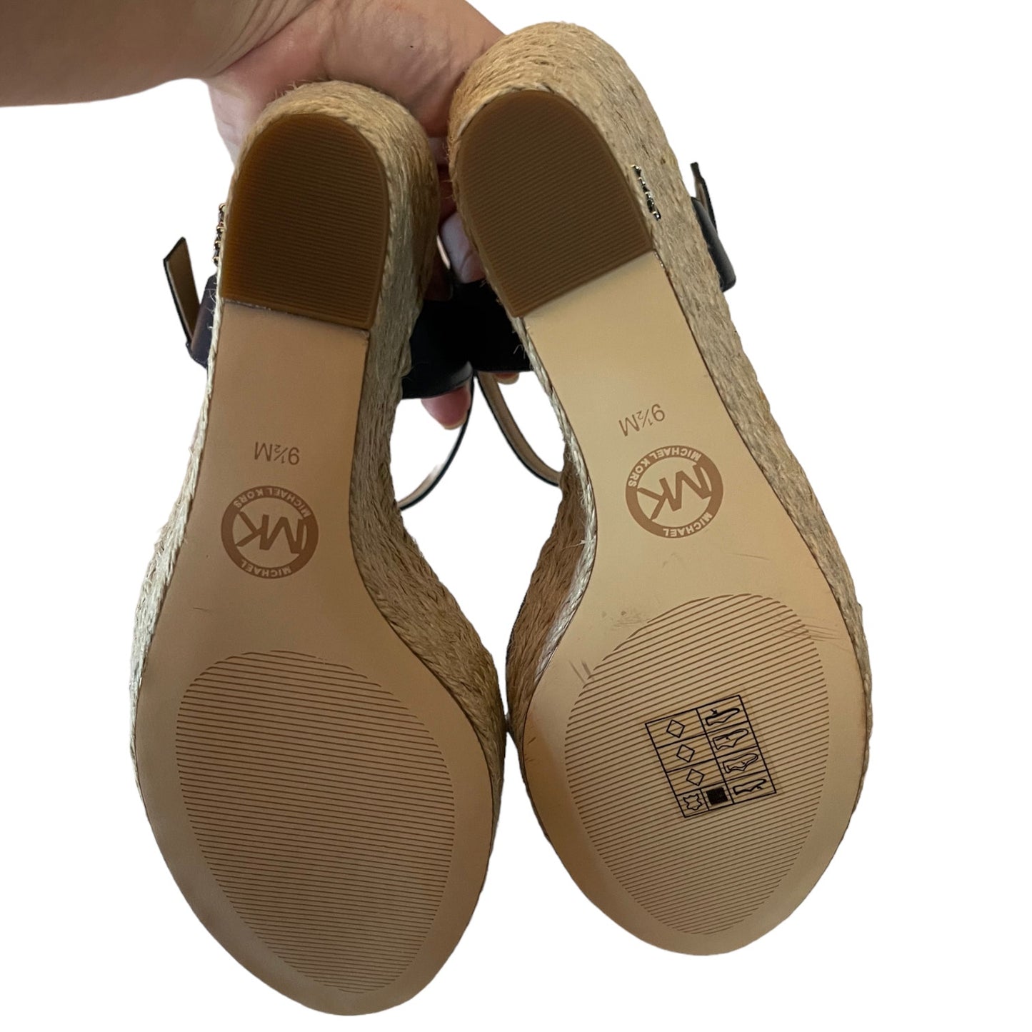 Pair of sandals with visible brand logo on the insole against a white background