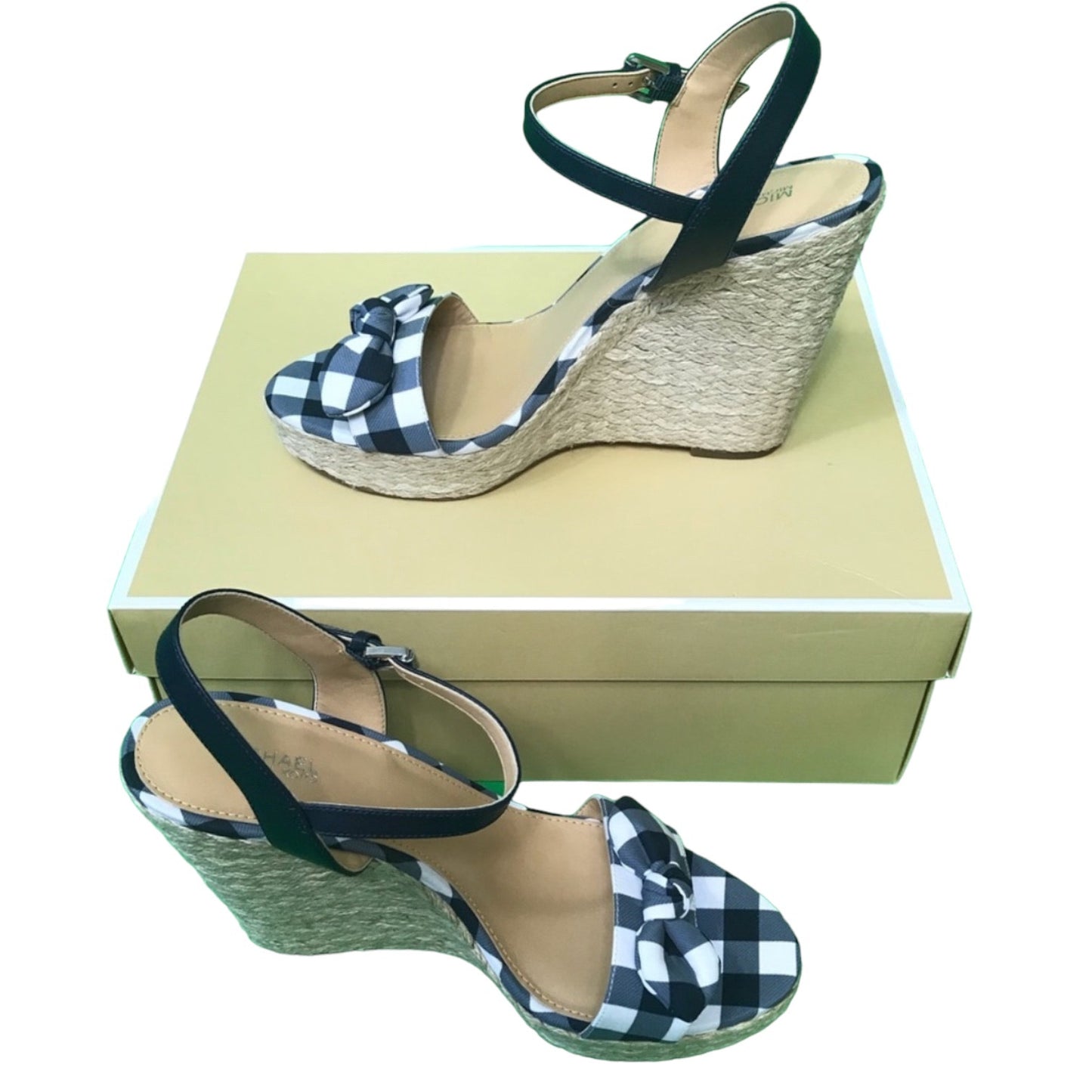 A pair of women's wedge sandals with  gingham check fabric uppers, ankle straps, and natural jute-wrapped wedge heels, displayed with a beige shoebox on a white background.