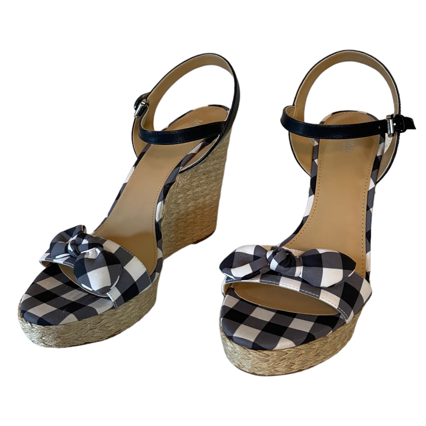Front of gray and white checkered wedge sandals with bow details on a white background