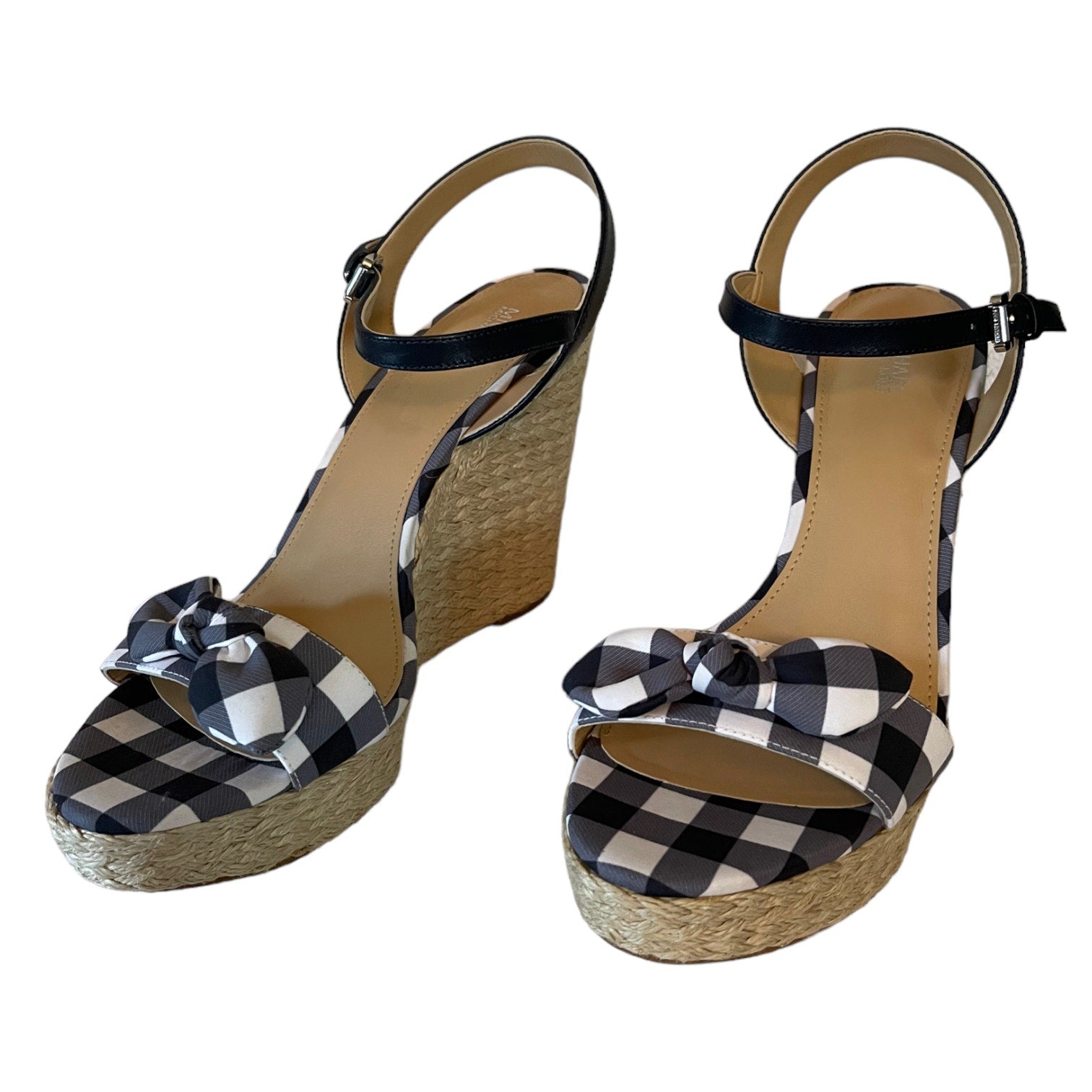 Front of gray and white checkered wedge sandals with bow details on a white background