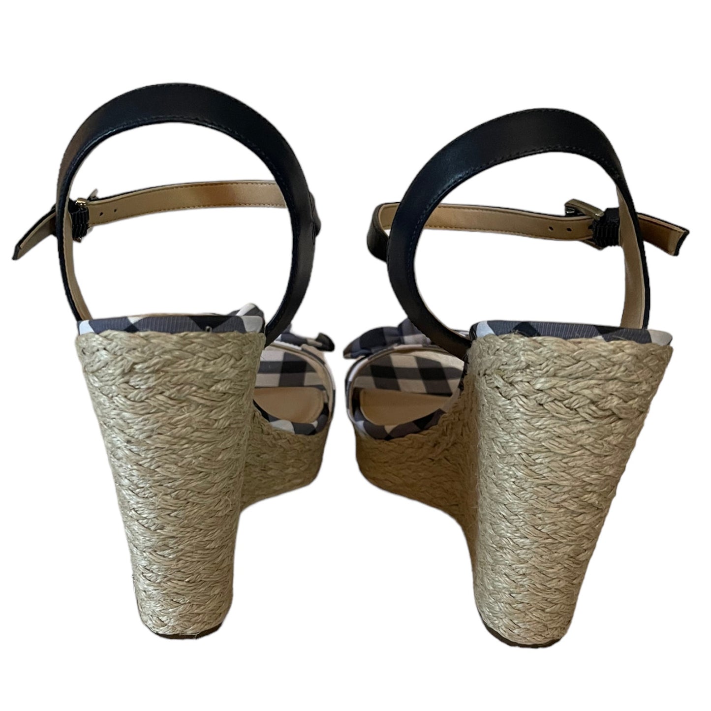 A pair of women's espadrille wedge sandals shown from the back, featuring a thick woven jute heel and platform, a  ankle strap.