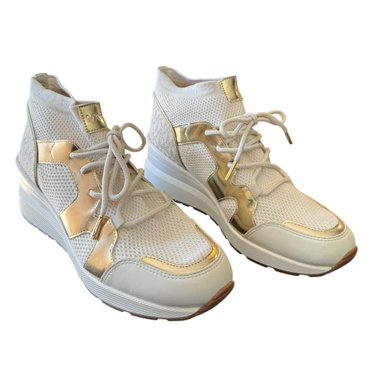 A pair of women's sneakers in white mesh with metallic gold accents on the sides, tongue, and toe caps, shown against a plain white background.