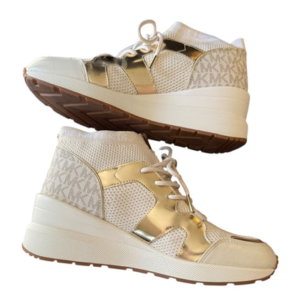 A pair of high-top sneakers shown from the side and bottom angles against a plain white background. The shoes feature a white mesh with metallic gold panels.