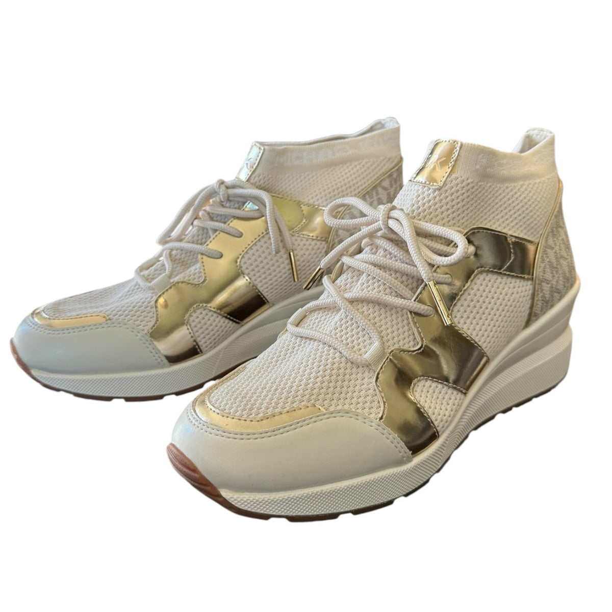 A pair of women's mid-top sneakers in white mesh with metallic gold accents and white laces, shown against a plain white background.