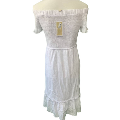 White off-shoulder dress on a mannequin with a visible tag against a white background