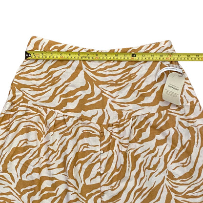 Skirt with brown and white pattern and measuring tape on a white background
