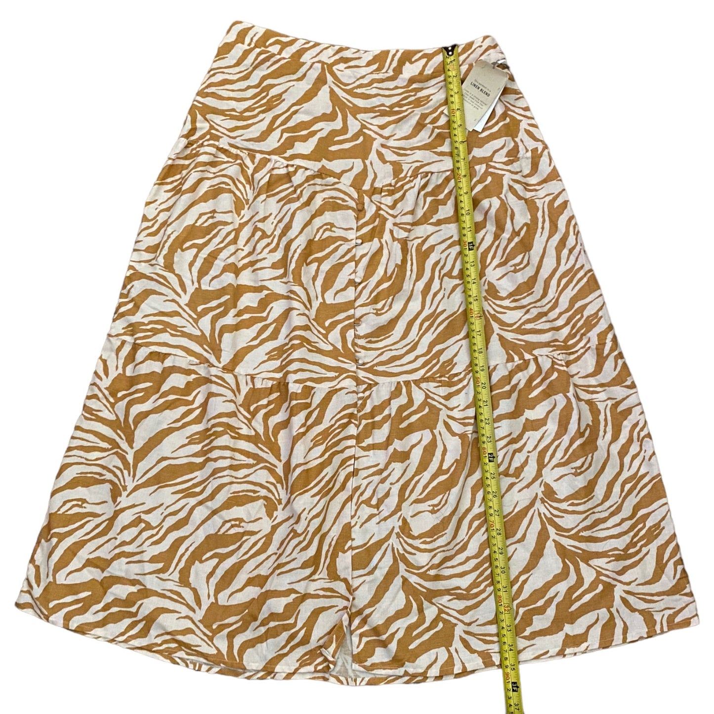 Skirt with zebra pattern and measuring tape on a white background
