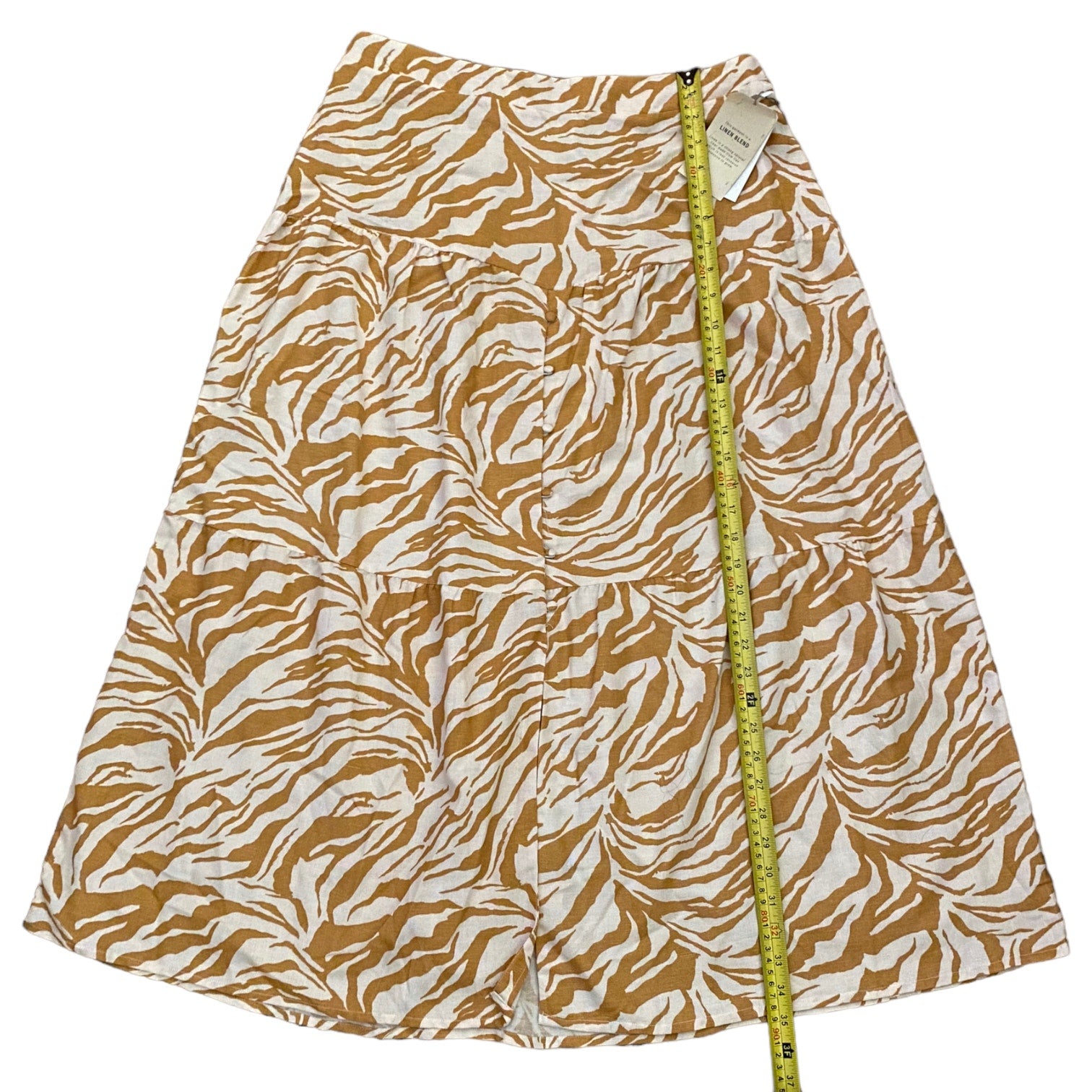 Skirt with zebra pattern and measuring tape on a white background