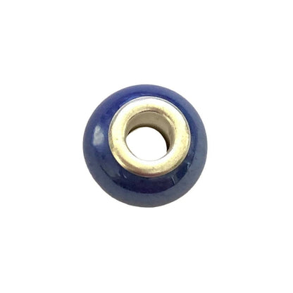 Dark blue and silver charm with odd mark on side