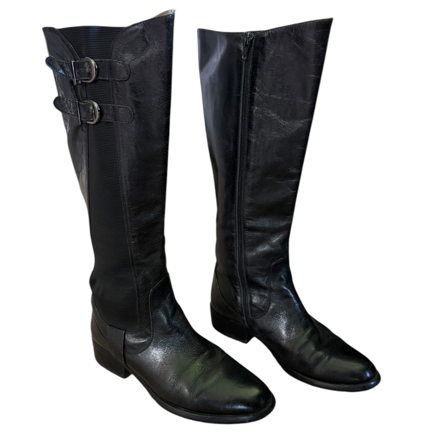Front side of Pair of black leather knee-high boots on a white background