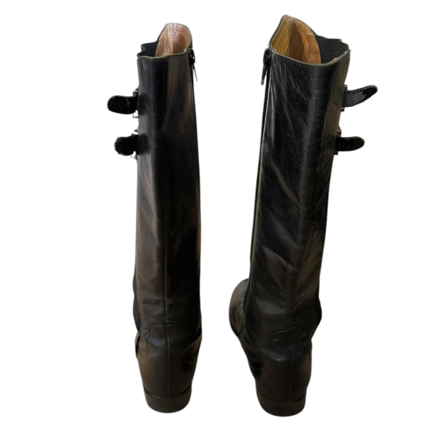 Back of a Pair of black riding boots on a white background