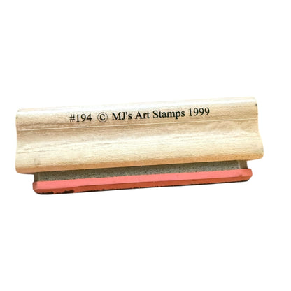 Wooden stamp with red rubber pad on a white background, featuring 'MJ's Art Stamps 1999' text.