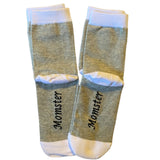 Pair of socks with 'Momster' text on a white background