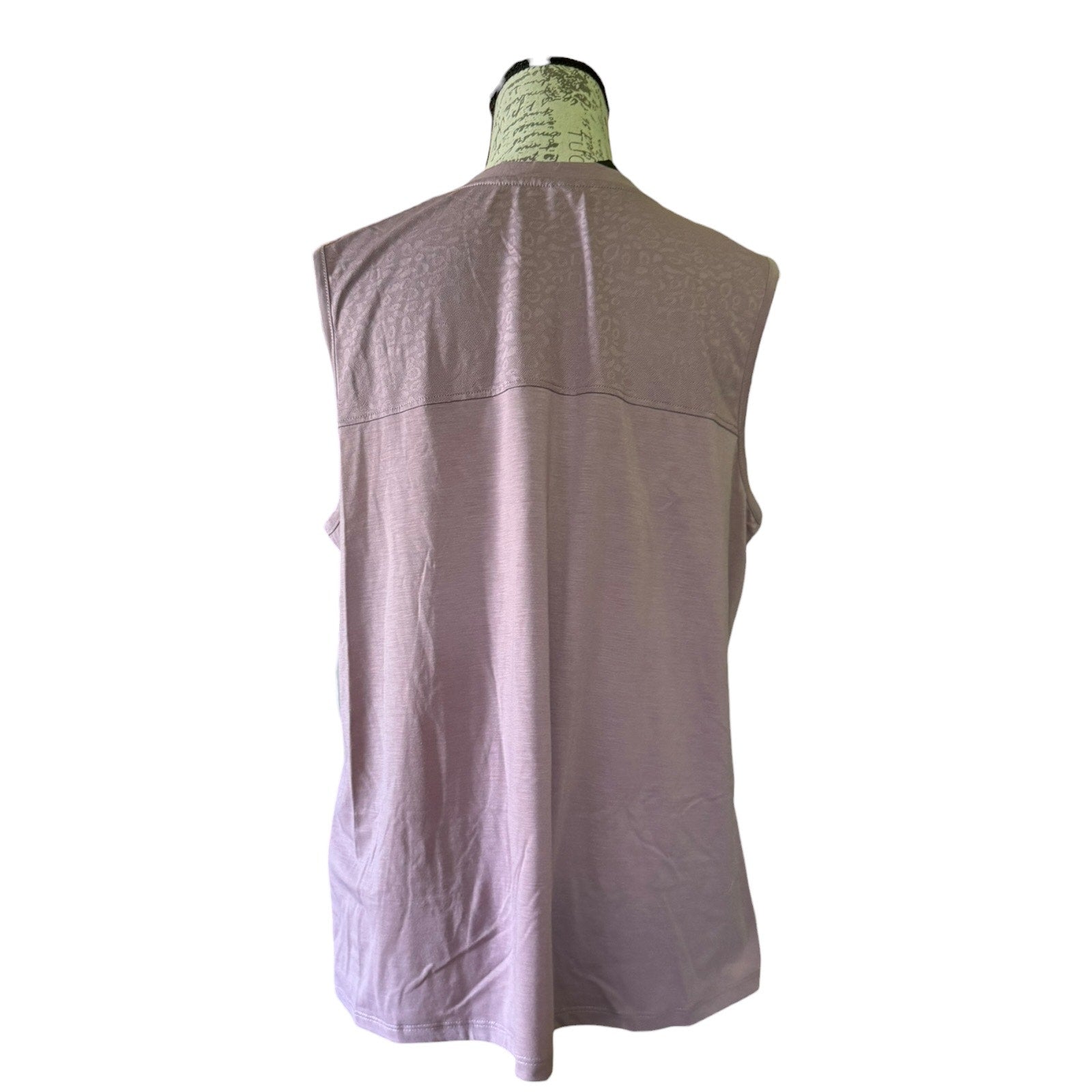 Back of purple shirt with lace detail on a white background.