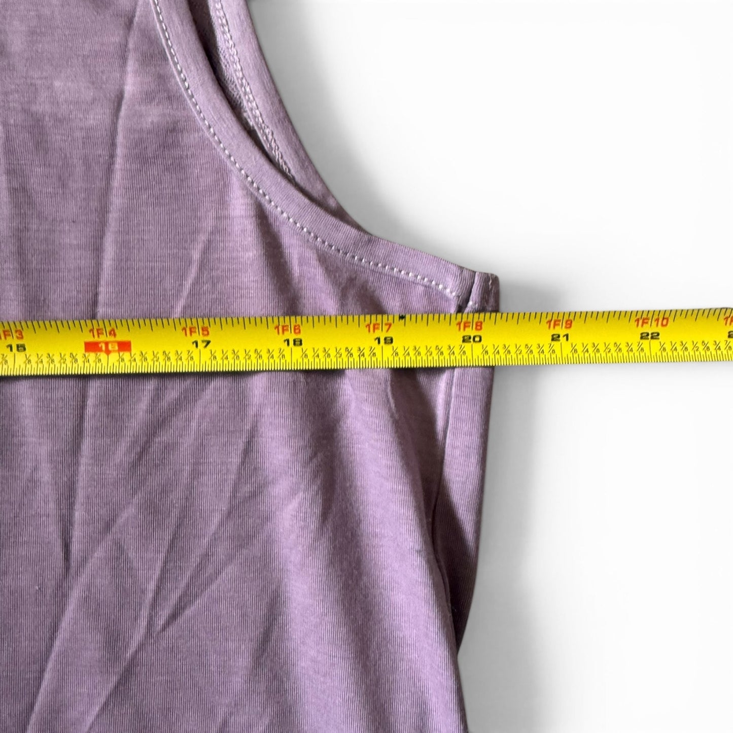 Purple shirt with a measuring tape on a white background