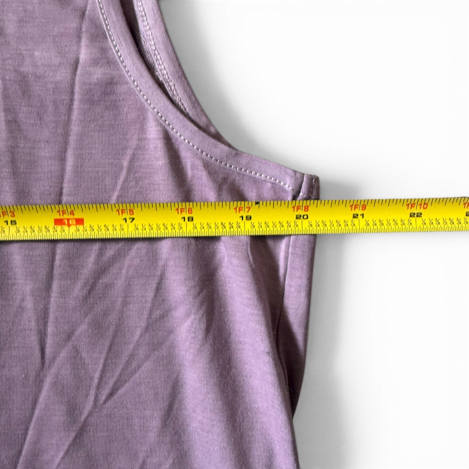 Purple shirt with a measuring tape on a white background