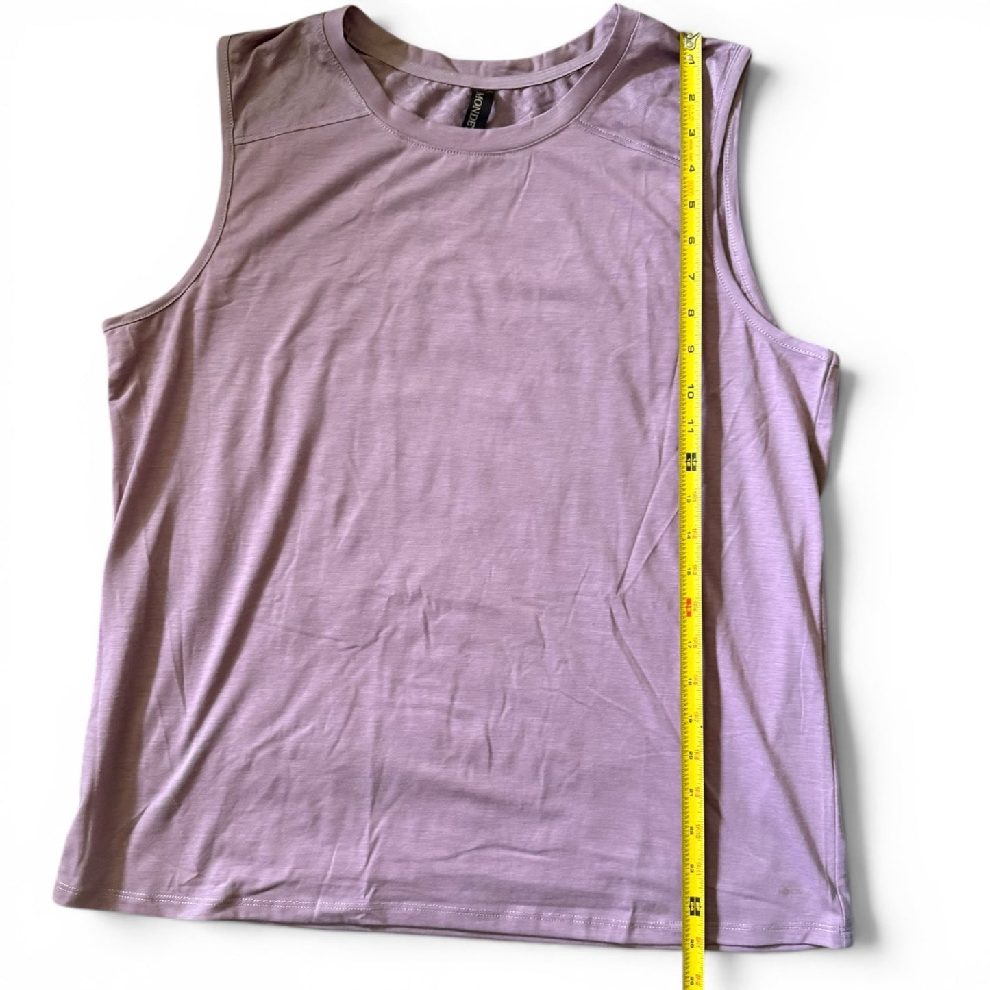 A sleeveless tank top in a purple color, laid flat on a white background with a yellow measuring tape vertically aligned to show the garment's dimensions.
