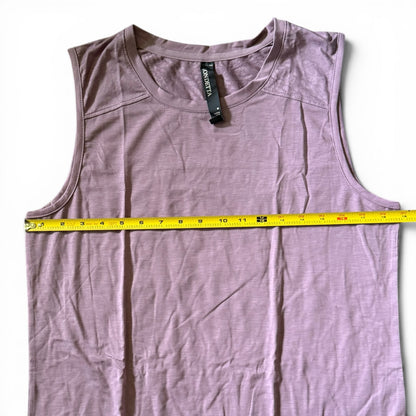 A sleeveless tank top laid flat on a white background, with a yellow tape measure stretched horizontally across the chest to show the width.