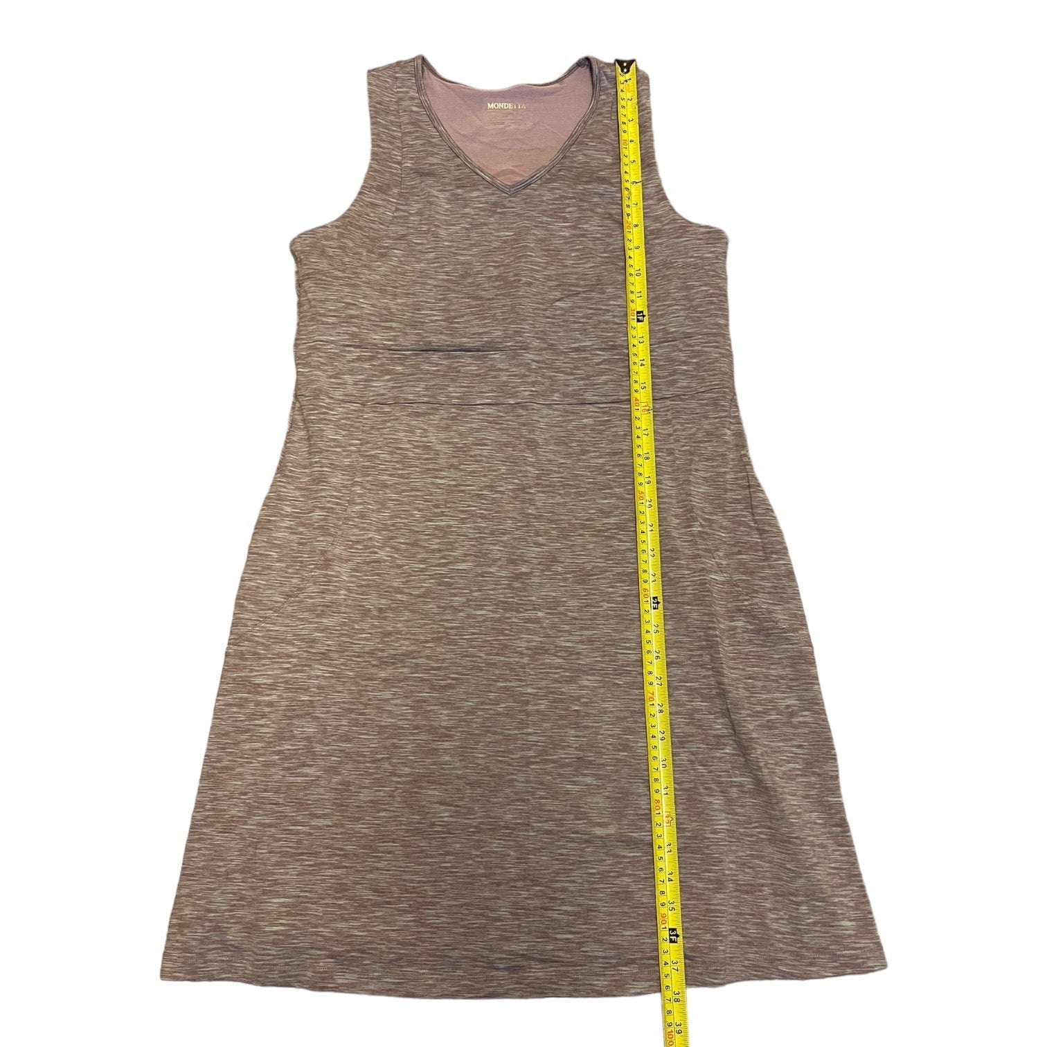 Purple sleeveless dress with a yellow measuring tape on a white background
