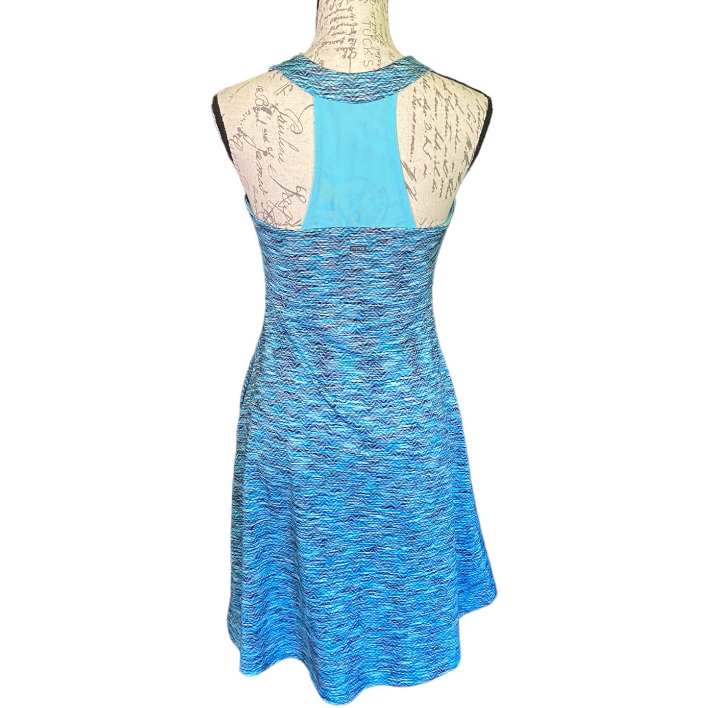 A sleeveless blue dress displayed on a dress form mannequin against a plain white background. 