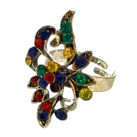 Colorful gemstone ring with a silver band on a white background