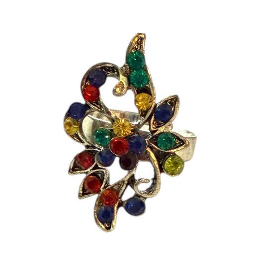 Decorative ring with colorful gemstones on a white background