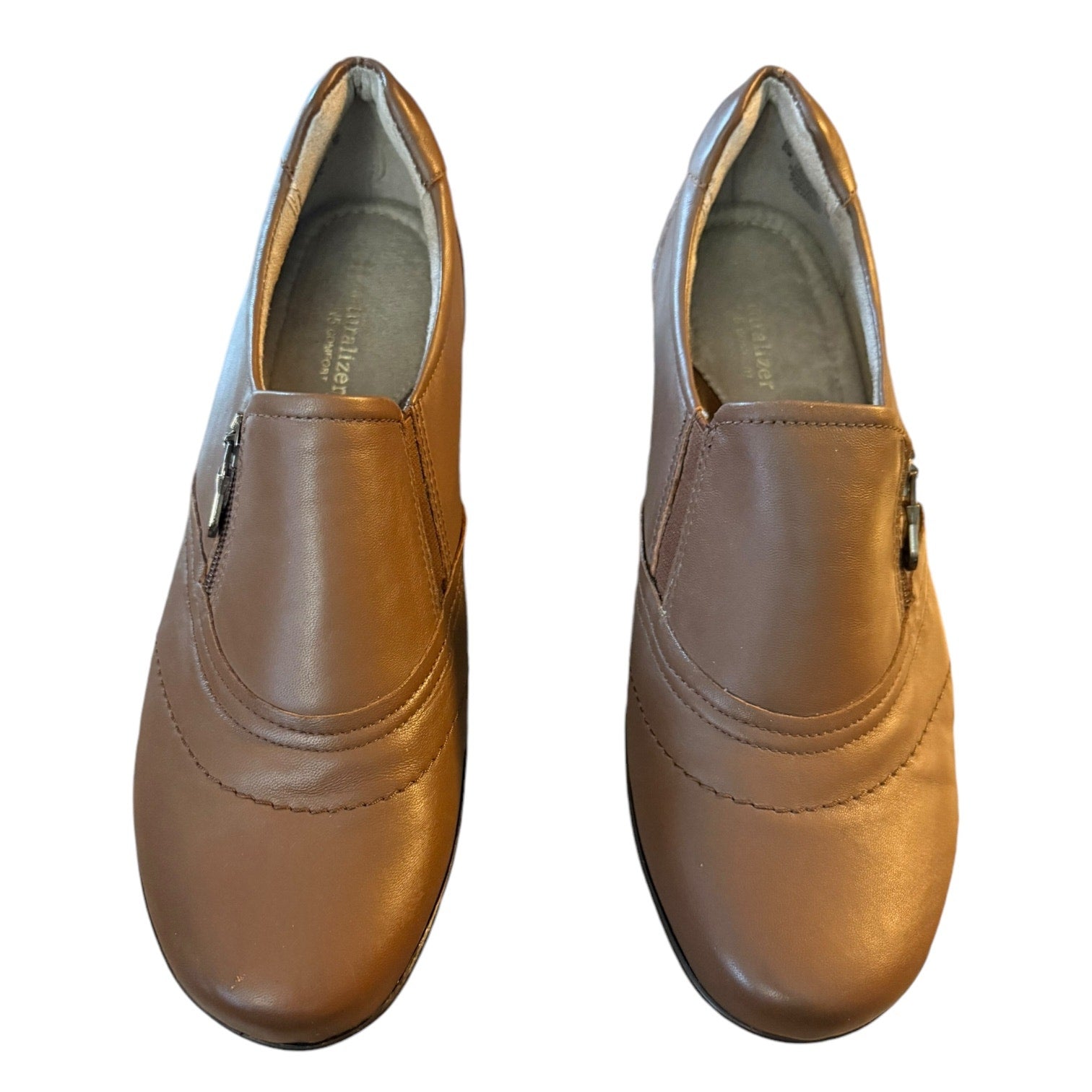 Front of Pair of brown leather shoes on a white background