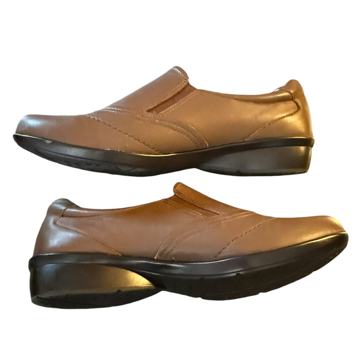 Pair of brown slip-on shoes on a white background
